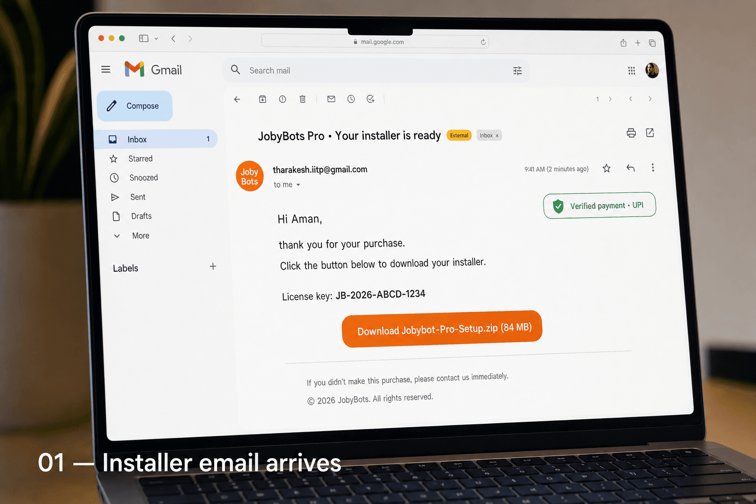 Gmail inbox open on a laptop showing the JobyBots Pro installer email with an orange download button